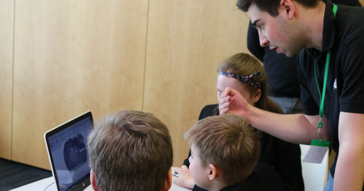 A CREATE Education workshop, one of our leaders talking to pupils who are taking part in 3D design before they 3D print. 